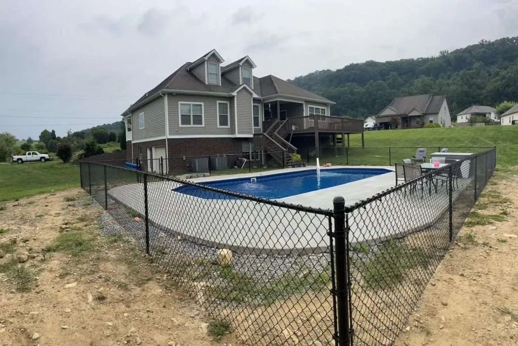 New black chain-link fence surrounding a clear blue pool in johnson city, tn.