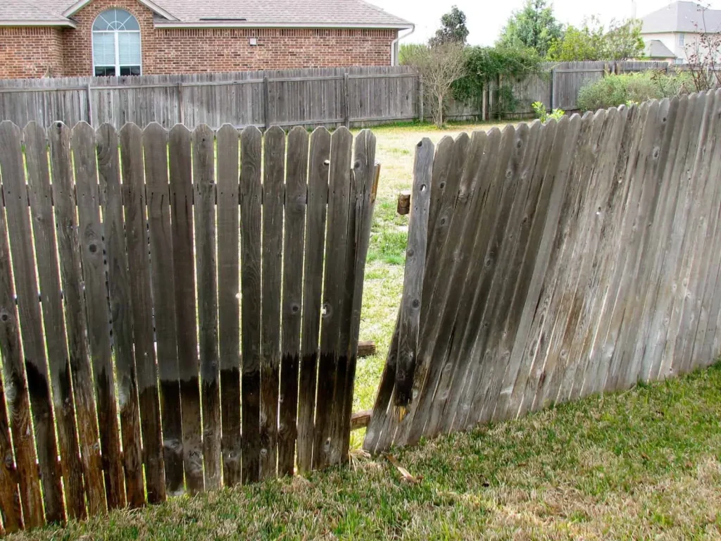 Damaged privacy fence with missing panels and structural weakness in Johnson City, TN.